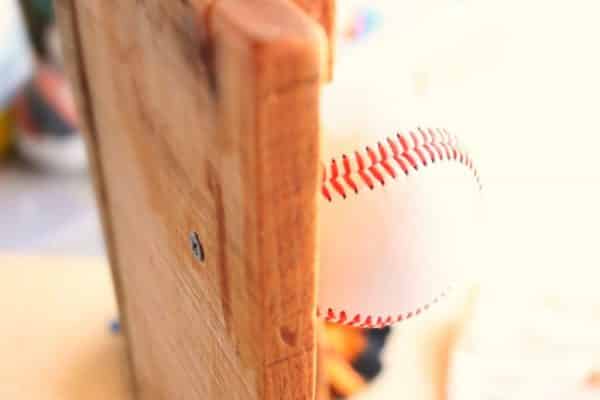 Attaching baseballs to baseball hat rack