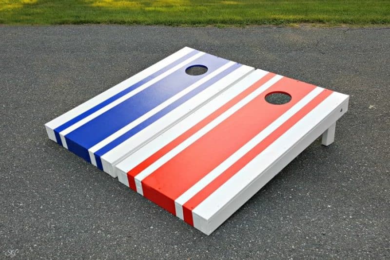 Red and Blue stripes on DIY cornhole board set. How to build cornhole boards DIY painted with red, white, and blue paint!