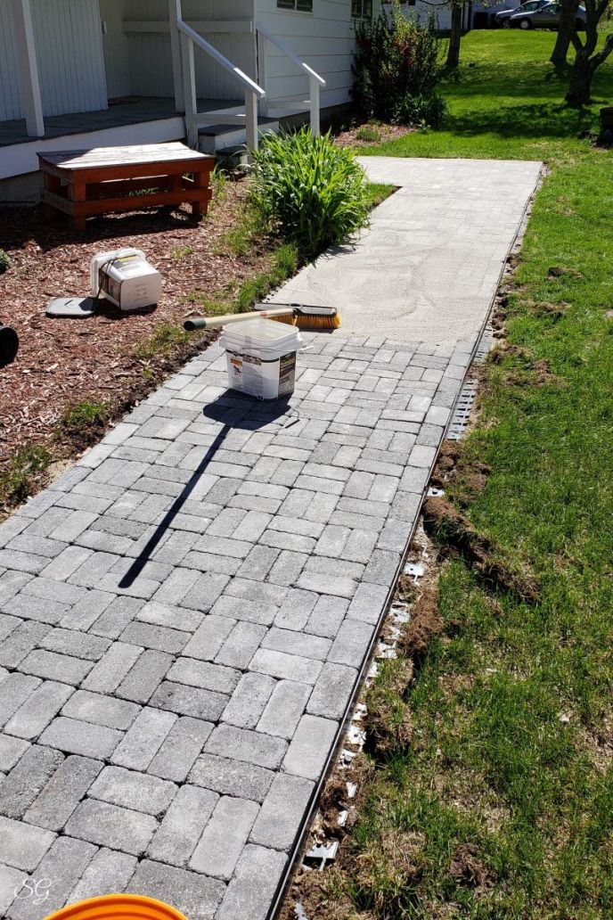 How To Install A DIY Paver Walkway, Installing polymeric sand on a paver walkway DIY project.
