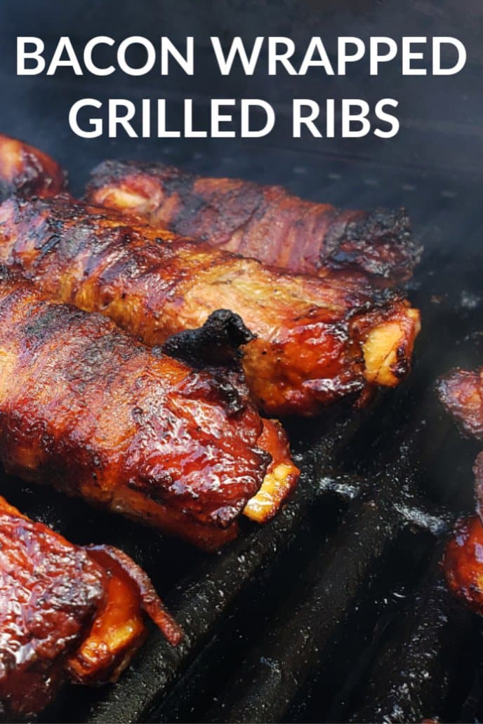 Grilling ribs wrapped in bacon on the barbecue