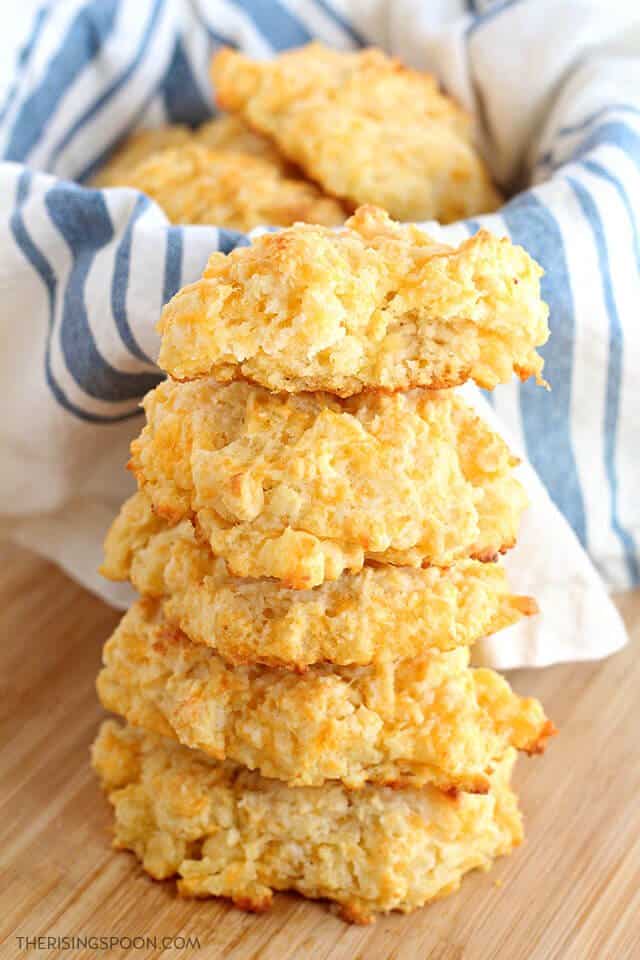 51+ No Yeast Bread Recipes, Homemade buttermilk drop biscuit recipe, finished biscuits stacked on top of each other basket of biscuits in the background