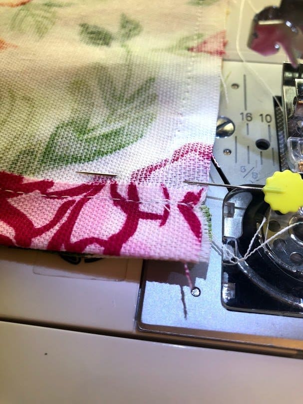 DIY Plastic Bag Holder, Sewing the edges of the fabric for DIY plastic bag dispenser.