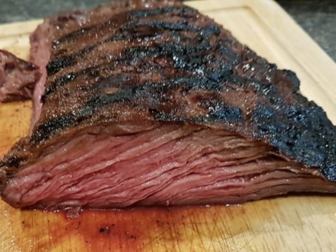 Flank steak cut to show inside after being marinated and cooked with this flank steak marinade recipe.