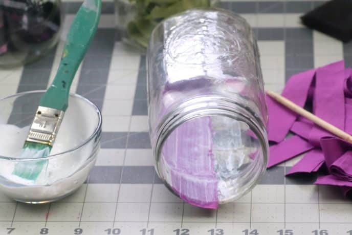 20 Mason Jar Crafts - DIY Flower Vases, Attaching fabric to the inside of a mason jar with mod podge to create a flower vase