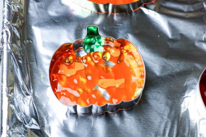 DIY Fall Pumpkin Suncatchers, Melting plastic beads for suncatchers.