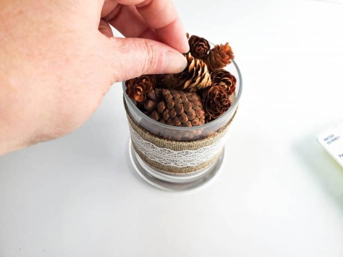 Pine Cone Centerpiece Craft, Arranging pine cones in a glass jar for a home decor piece or pine cone ceterpiece.