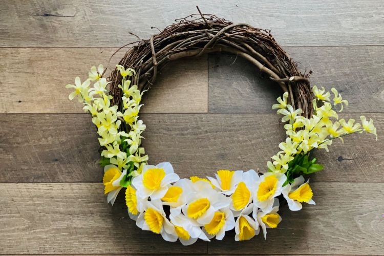 Flower wreath with daffodils and grapevine.